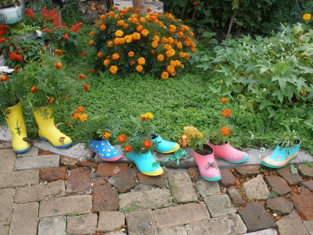 creative upcycling ideas colorful flower boots garden border