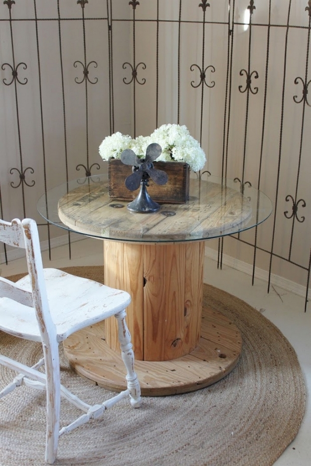 wooden cable spool table glass top white chair burlap carpet flower centerpiece