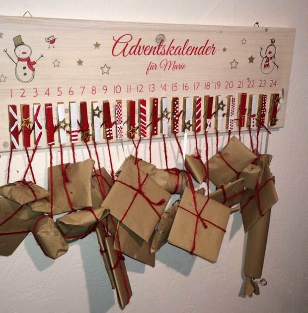 upcycling christmas calendar from recycled clothespins hanging wrapped gifts