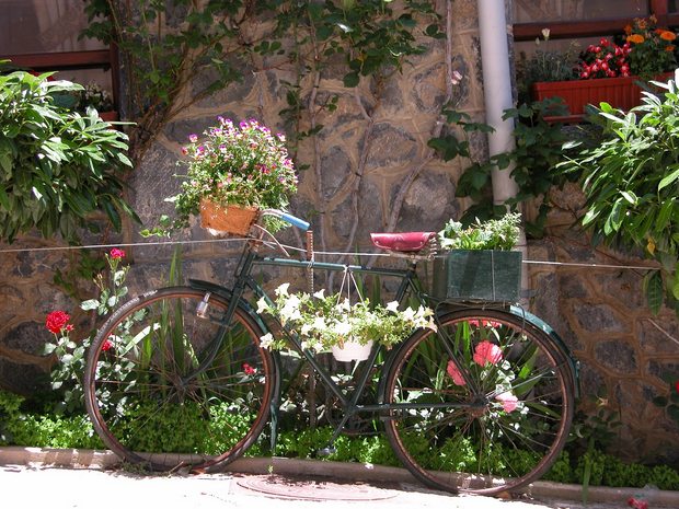 upcycled old green bike into garden flower planter decoration