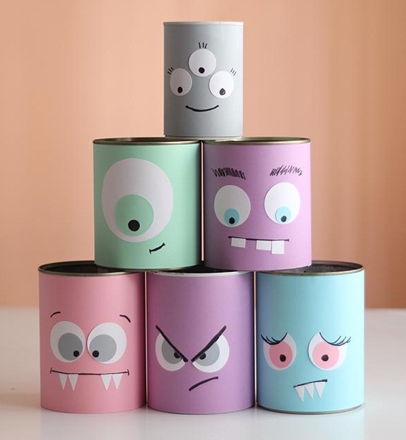 reused old tin cans as halloween crafts for kids with funny decoration