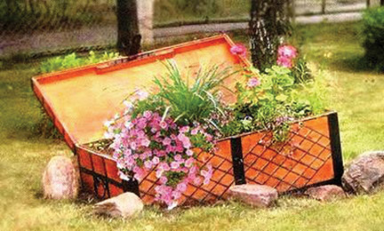 upcycling garden ideas wooden chest flower planter stone border