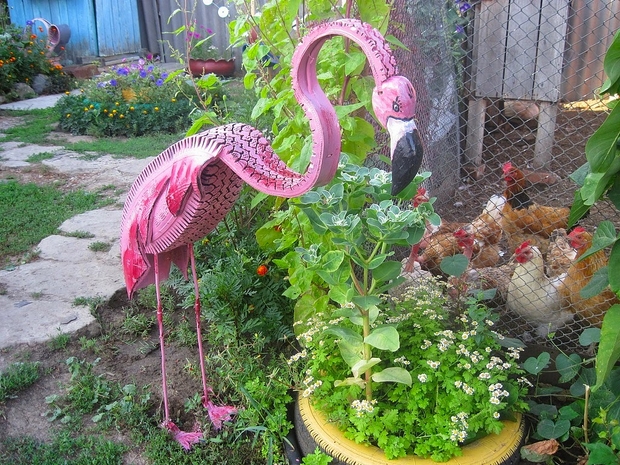 Tire recycling ideas old unwanted tires pink dig flamingo art garden diy used tire idea hens plants backyard