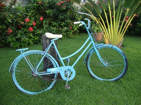 blue painted reused bike in the garden as amazing decoration