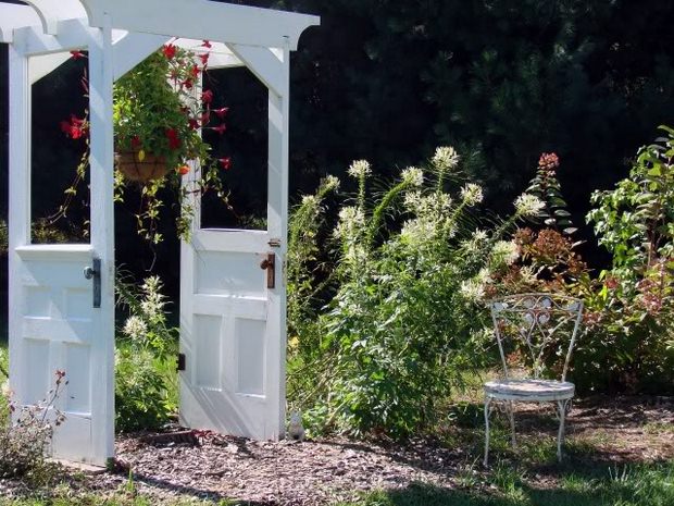 recycling old wooden doors garden arbor flowers white chair repurposed patio ideas